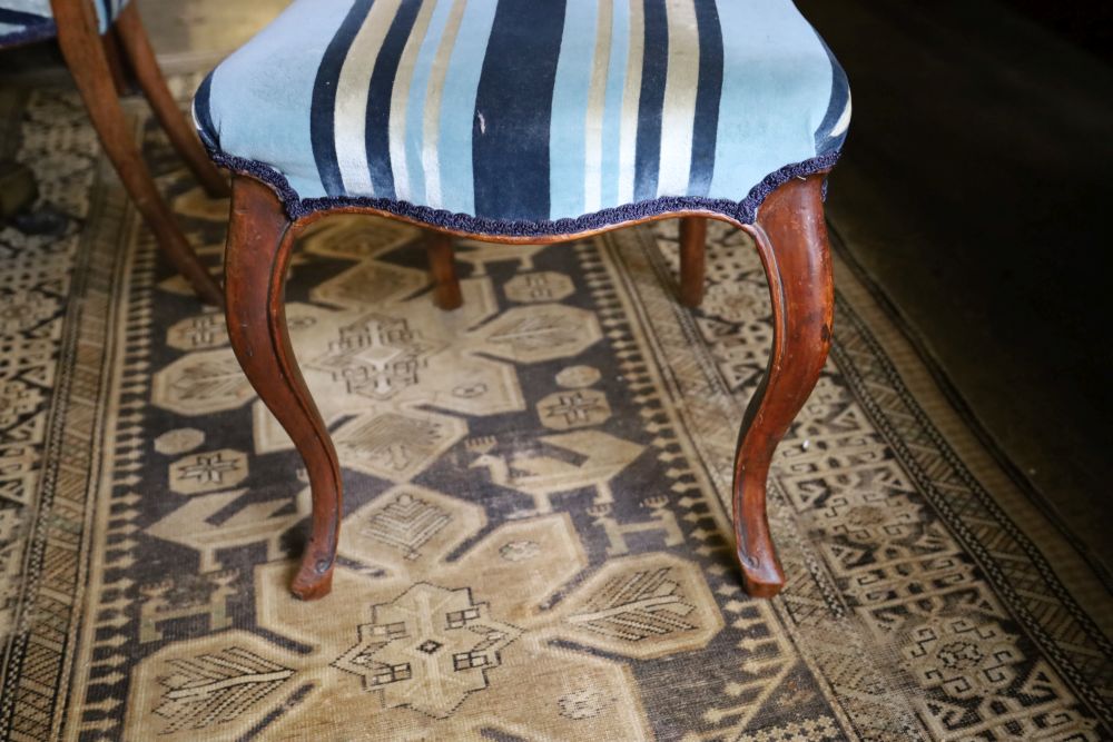 A set of four Victorian walnut balloon-back chairs